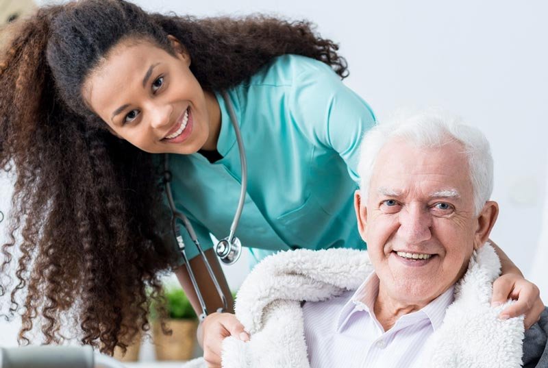 Medical caretaker assisting senior man